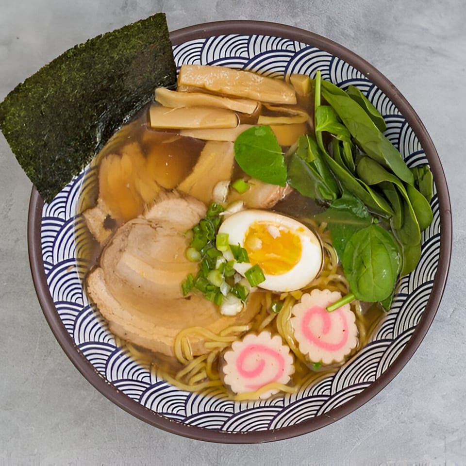 A bowl of Kailani Shave Ice & Ramen's ramen with pork, egg, spinach, bamboo, and nori.