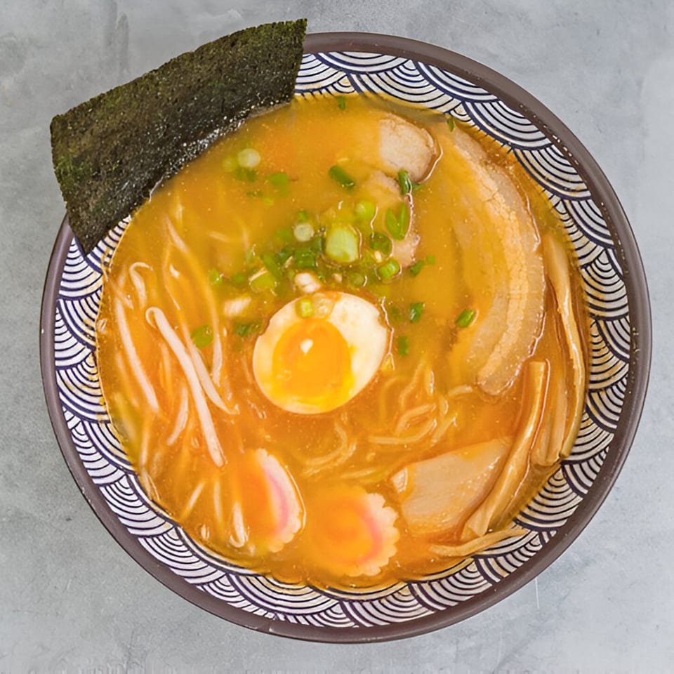 Overhead view of a bowl of Kailani Shave Ice & Ramen's ramen with egg, pork, and seaweed.