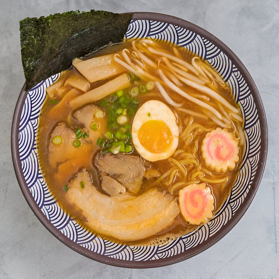 A bowl of Kailani Shave Ice & Ramen's ramen with pork, egg, bamboo, bean sprouts, and nori.